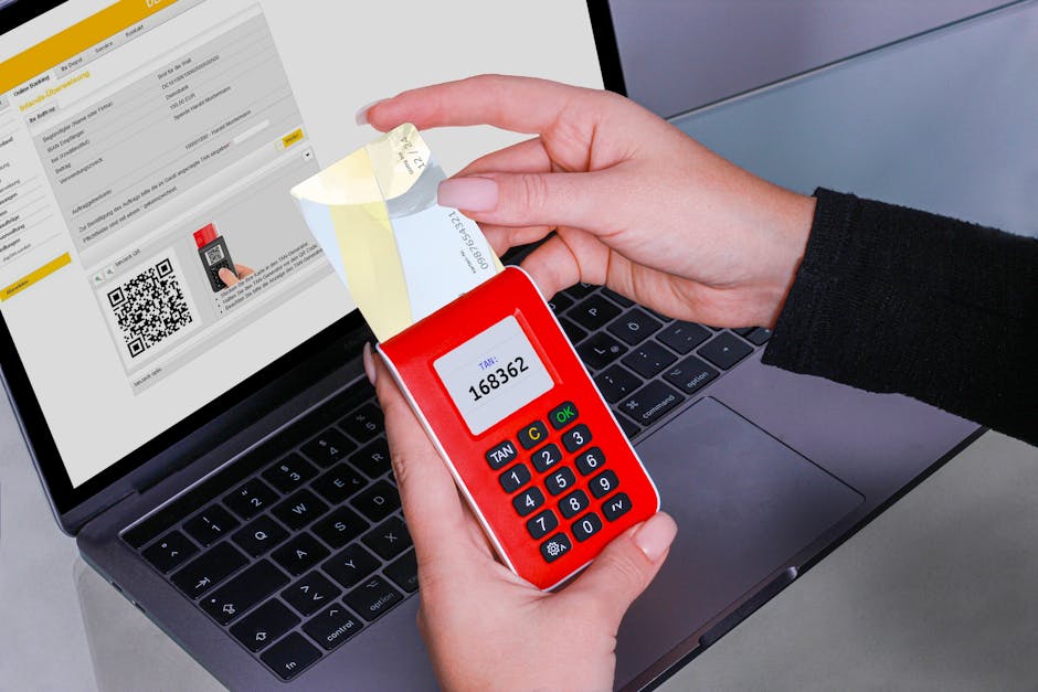 Woman using TAN generator for secure online payment on laptop, enhancing cybersecurity.
